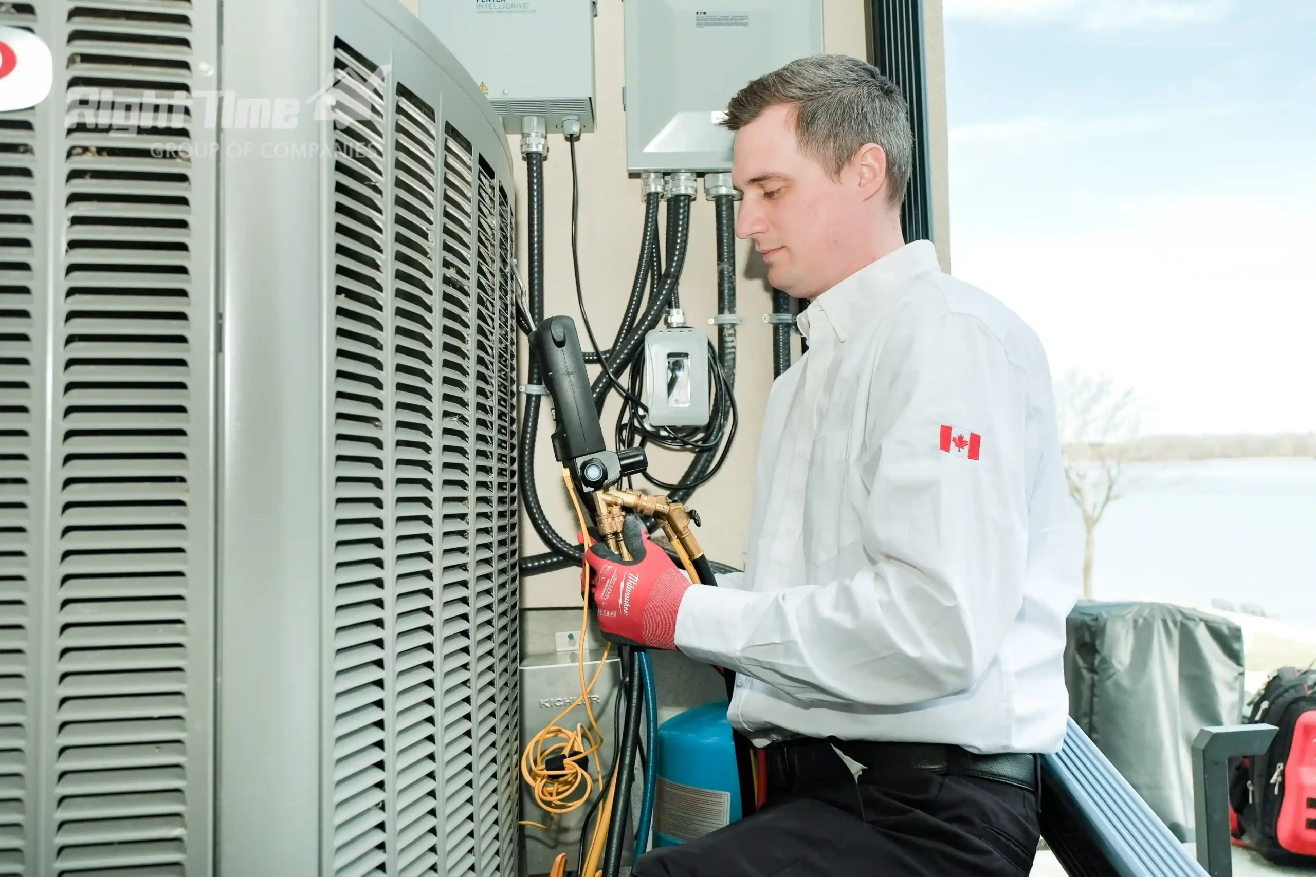 Technician servicing heat pump outside Hamilton home, illustrating air-source, ductless mini-split, and hybrid system performance in Ontario winters.