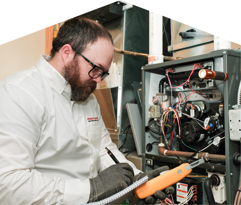 Technician inspecting a furnace