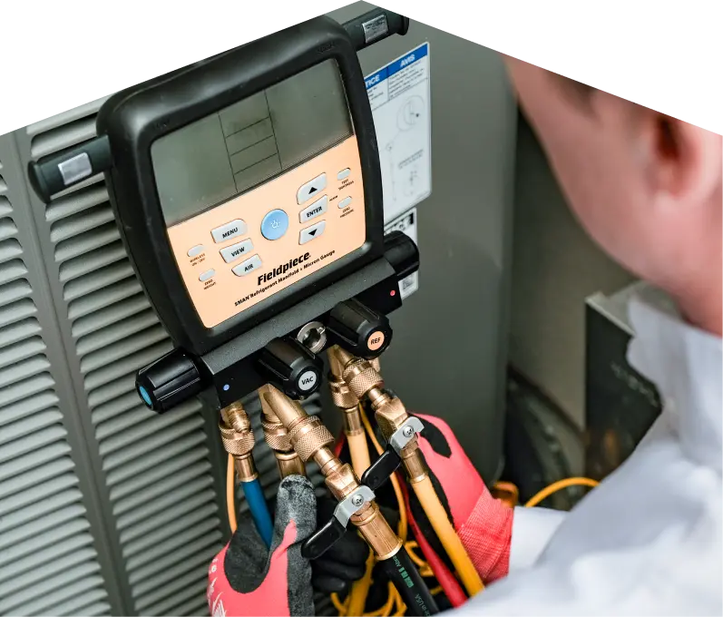 Technician using equipment to inspect a unit